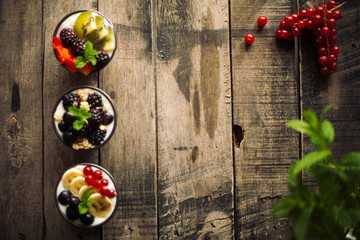 Proteic greek yogurts with fruits: banana, berries, kiwi