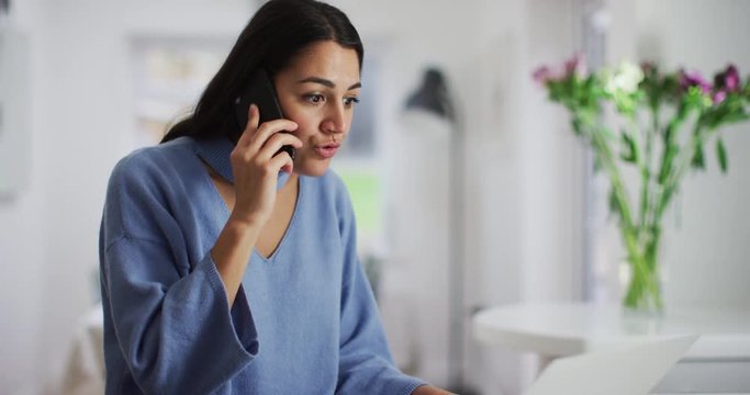 4K Assertive Spanish speaking businesswoman dealing with a problem over the phone. Slow motion.
