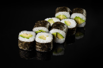 Sushi Roll - Maki Sushi pieces collection with Salmon Roe, Smoked Eel, Cucumber, Cream Cheese, Sesame, Avocado, Onion Fries, Crab Meat, Tobiko isolated on black background - Image