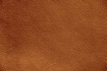 Fototapeta premium The texture of genuine leather. Impeccable and stylish background. Beautiful stylish background. Natural skin texture close up. Brown background. The structure of the leather material brown shades.