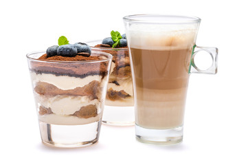 Classic tiramisu dessert with blueberries in a glass and cup of coffee isolated on a white background with clipping path