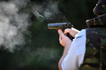 Outdoor target shooting with a 9mm pistol in a shooting range