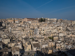 Panoramic view of typical stone houses of Sassi di Matera and church under blue sky with clouds, capital of europe culture 2019. April, 2019