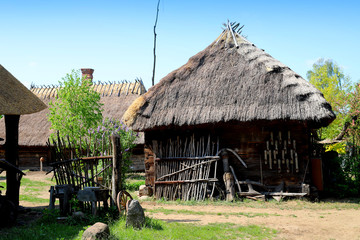 an old house in the countryside with a straw roof, Poland