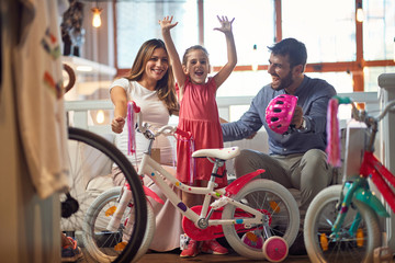 Obraz premium Sale, consumerism and people concept - happy family with child and shopping new bicycle.