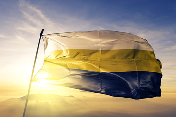 Perak state of Malaysia flag waving on the top sunrise mist fog