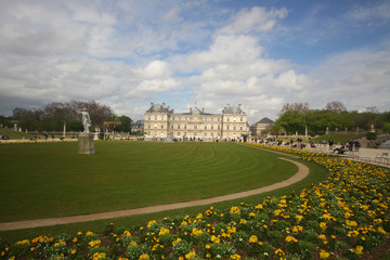 Obraz premium Relaxation on cloudy sky in the summer at green beautiful field public park in Paris, luxembourg garden, France, travel destination backgrounds, 