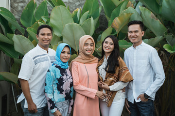 pose of friendship standing and smiling together when gathering on backyard