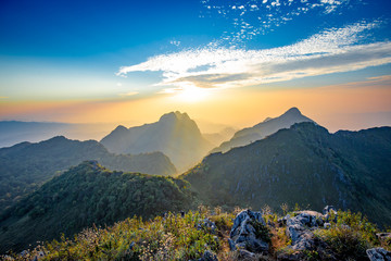 Golden Cloud and sunset sky at wildlife sanctuary name Doi Luang Chiang Dao, Thailand with Shadow of mountain layer and sun ray.