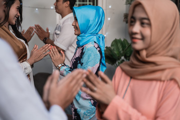 veiled woman and young man greet each other apologizing during the Eid holiday