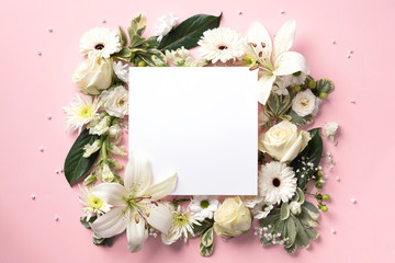 Creative layout with white flowers, square shape paper for copyspace over pink background. Top view, flat lay. Spring and summer concept.