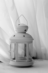 lantern with an overhang on a table in the background