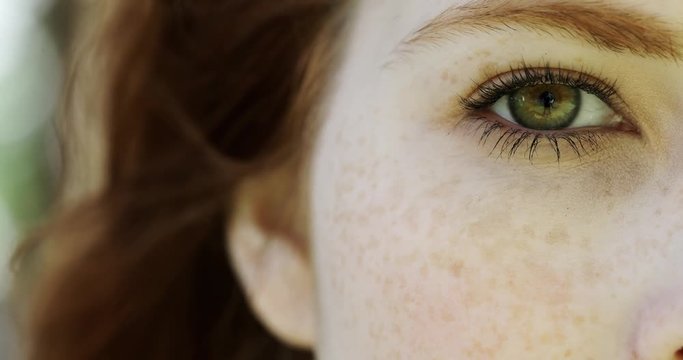 Close-up of eyes of beautiful woman with freckles