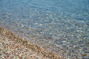Blue sea and pebbles background