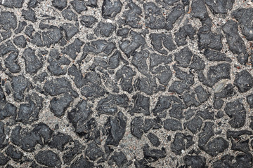 Abstract unusual background of small stones and black blots