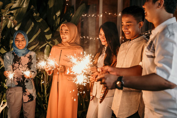 happiness lighting the takbir night fireworks with friends while celebrating the Eid holiday