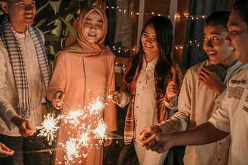 Playing firework to celebrate Eid Mubarak with friends at hometown