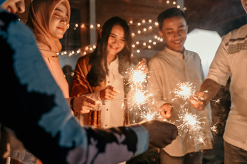 happiness lighting the takbir night fireworks with friends while celebrating the Eid holiday