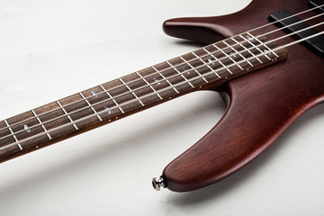 Maroon colored electric bass guitar
