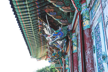  Ancient decoration wood carved on the wall and roof in the temple in Pusan, South Korea