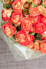 Large beautiful bouquet of orange roses in the package