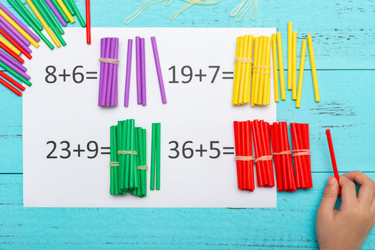kid doing addition equations using counting rods