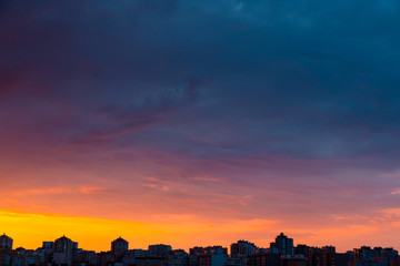 Modern city skyline. Dramatic stormy clouds over modern residential buildings.
