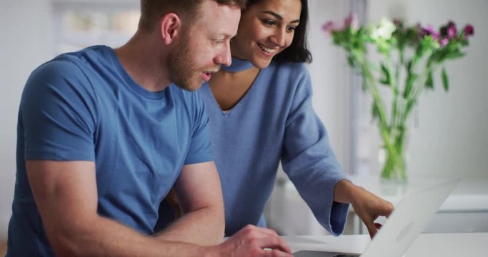 4K Happy couple shopping online & getting excited about their purchases. Slow motion.