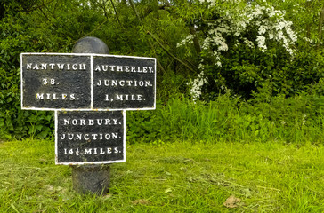 Detail of an unusual 19th Century black and white cast iron maker post on the Shropshire Union Canal. Public towpath, Pendeford, West Midlands.