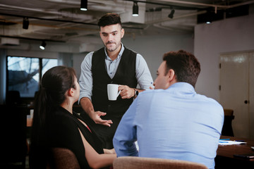 Naklejka premium Businessmen are brainstorming in the meeting room. There is a discussion of the strategy of working in accordance with the world economic remnants. In order to achieve the goal And have more profit