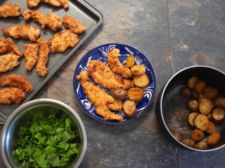 Traditional Fried Chicken Strips Plate with Potatoes and fresh Green Salad 