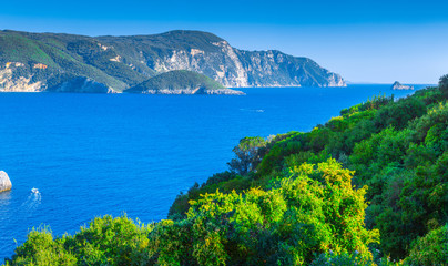 Beautiful summer panoramic seascape. View of Paleokastritsa famous beach in close bay with crystal clear azure water on Corfu island, Ionian archipelago, Greece.