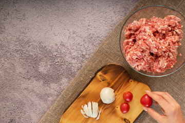 Fresh, minced meat in a plate on the table in the kitchen. Cooking minced meat for meatballs.