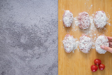 Raw meat patties for frying. The process of cooking meatballs.