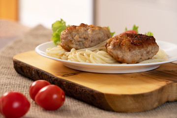 Ready meat patties with salad in a plate on the table. Dish homemade.