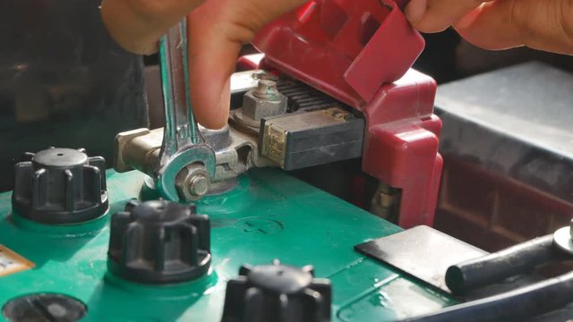 Hand close up of a msn to check and replace car battery