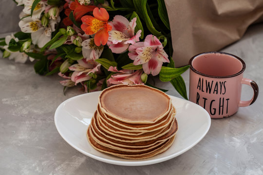 Pancaces with cup of coffee on white table