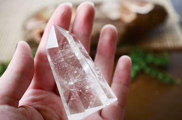 Woman's hand holding clear quartz! Beautiful translucent Quartz specimen, bright colors in natural...