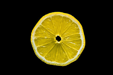 macro shot of a lemon slice on isolated black background