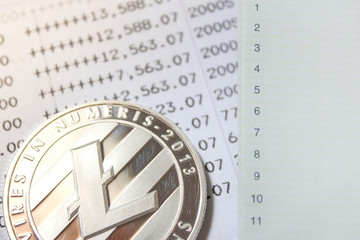 one litecoin on account book background
