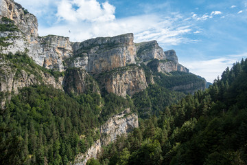 Fototapeta na wymiar Scenic rocky mountains with deep forests and cliffs in Monte Perdido National Park, Spain