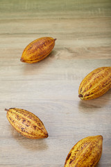 Fresh cocoa pods on table