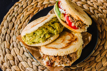 Arepas venezolanas is a traditional dish from Venezuela and Colombia, on a rustic background