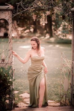 Woman Stepping Through Garden Gate