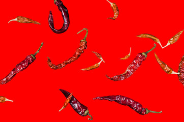 cayenne pepper pod on a red background, isolate