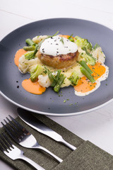 Beef cutlet served with mashed potatoes, broccoli and cauliflower