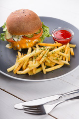 Burger served with french fries and ketchup