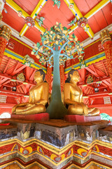 Fototapeta na wymiar Lampang, Thailand - December 28, 2018: Four Buddha sculpures in pavilion at Wat Pong Sanuk temple and museum in Lampang, North of Thailand