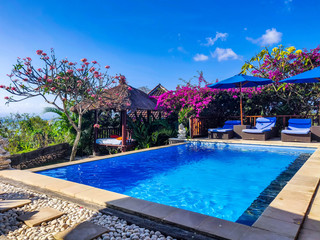 View to pool and bungalove in a Balinese apartment