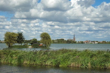 Scenic view of a lake and distant village in the western part of The Netherlands